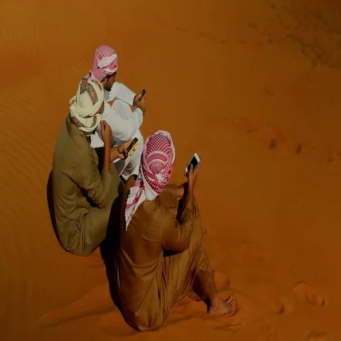 Arab men using cell phones on desert. Stock Footage 69482962