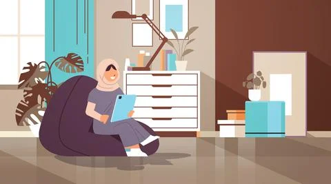 Arab schoolgirl using tablet pc arabic girl sitting on beanbag and doing Stock Illustration