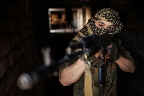 Arab soldier aiming with Kalashnikov AK-47 assault rifle Stock Photos