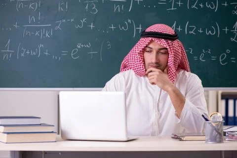 Arab teacher in front of chalkboard Foto stock