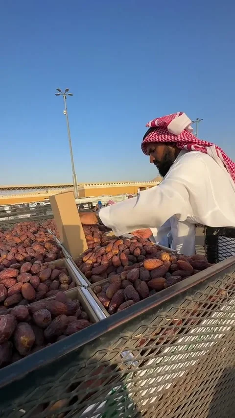 Arab Vendor Sorting Fresh Dates at an Outdoor Market Stock Footage 346533421
