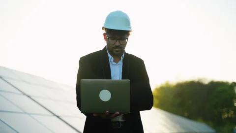 Arabian engineer inspecting solar panels with laptop Stock Footage 314408381