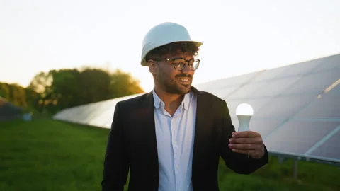 Arabian engineer showing light bulb and thumb up near solar panels Stock Footage 314410157