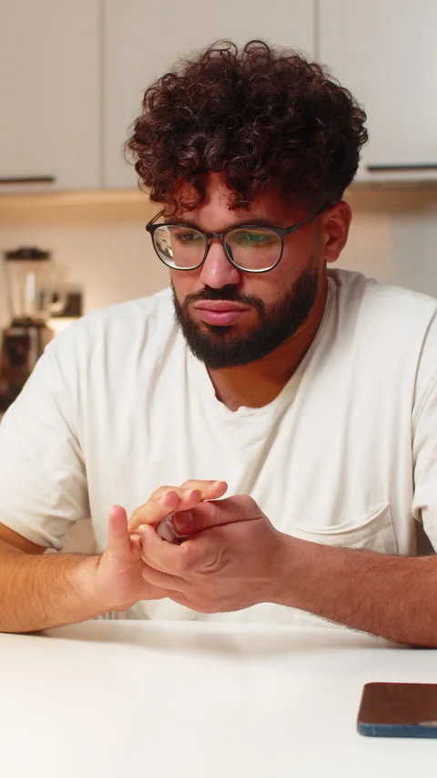 Arabian man crumples utility bill angry calms smooths receipt plans to call Stock Footage 333459040