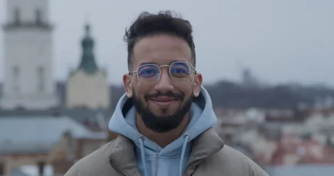 Arabian man stands against cathedral smiling in camera 스톡 동영상 171161453