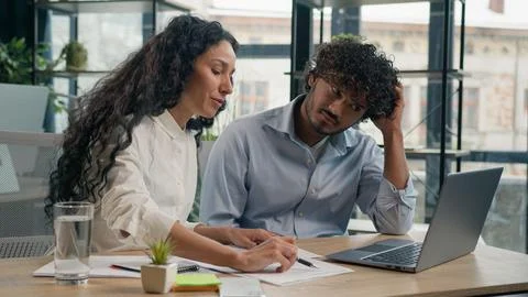 Arabian mentor help silly intern Indian coach advise trainee explain computer Stock Photos