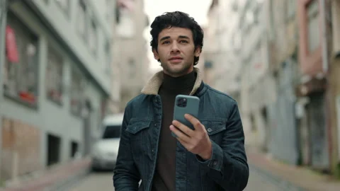 Arabian tourist using smartphone while walking on street Stock Footage 161603901