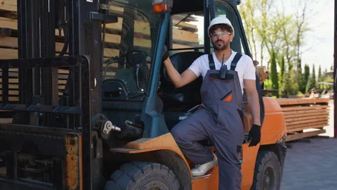 Arabian warehouse worker posing on forklift Stock Footage 316714479