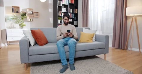 Arabian young handsome man checking some information on smartphone and doing Yes Stock Footage 179941250