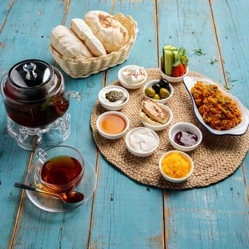 Arabic breakfast platter coffee, bread, salad, sauce, dip and pickle isolated Foto stock