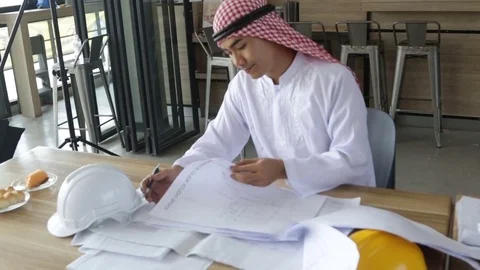 Arabic businessman working with blueprint Stock Footage 80266686