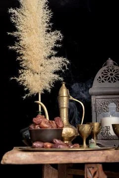 Arabic coffee and dates set up. black background. Stock Photos