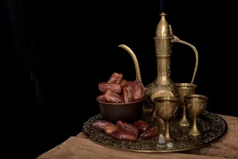 Arabic coffee and dates set up. black background. Stock Photos