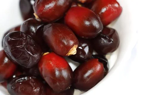 Arabic Dark Red Date Palm Fruits In White Background. Selective Focus Stock Photos