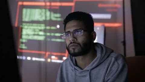 Arabic IT specialist working on computer at night. Hacker breaking computer code Stock Footage 71583780
