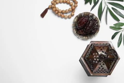Arabic lantern, dates and misbaha on white background, top view Stock Photos