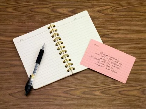 Arabic; Learning New Language Writing Words on the Notebook Stock Photos