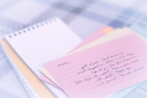 Arabic; Learning New Language Writing Greetings on the Notebook Stock Photos