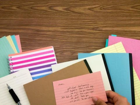 Arabic; Learning New Language Writing Words on the Notebook Stock Photos