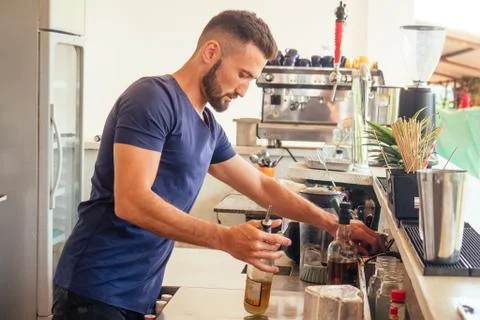 Arabic man bartender making fresh coctail for lady Stock Photos