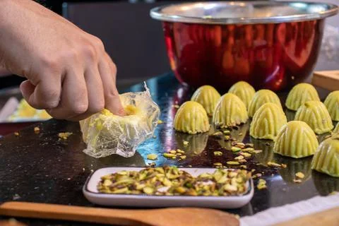 Arabic man hands while making keto eid kahk at home Stock Photos