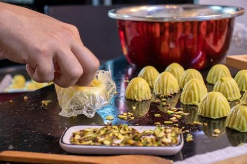 Arabic man hands while making keto eid kahk at home Stock Photos