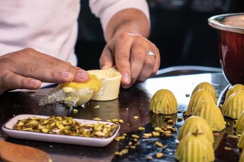 Arabic man hands while making keto eid kahk at home Foto stock