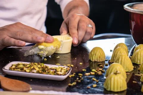 Arabic man hands while making keto eid kahk at home Stock Photos