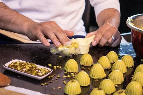 Arabic man hands while making keto eid kahk at home Stock Photos