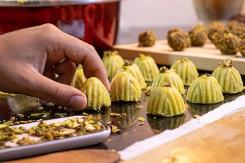 Arabic man hands while making keto eid kahk at home Stock Photos