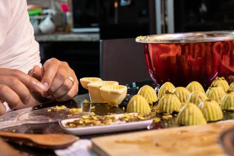 Arabic man hands while making keto eid kahk at home Stock Photos
