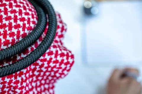 Arabic man holding pen while reading the contract before signing it Stock Photos