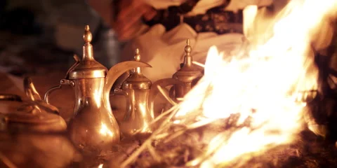 An Arabic man sitting at a camp fire at night. Stock Footage 46870669