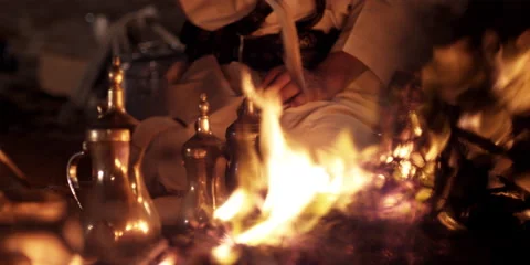 An Arabic man sitting at a camp fire at night. Stock Footage 46870672