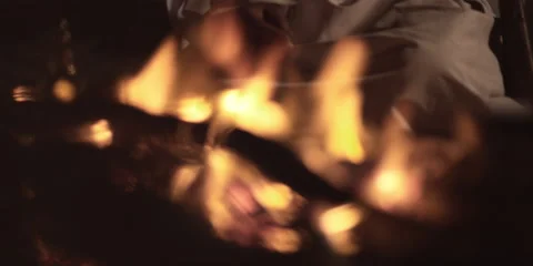 An Arabic man sitting at a camp fire. Video stock 46870806