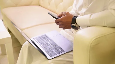 Arabic man working on laptop and mobile Stock Footage 73518672