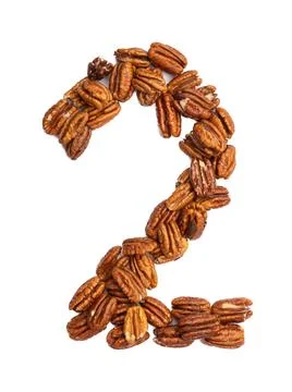 Arabic numeral "2"  from pecans on a white isolated background. Food pattern  Illustrazione stock