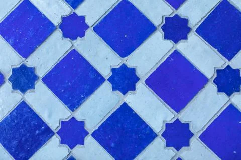 Arabic pattern on a tiled wall of a Muslim building, abstract background and Stock Photos