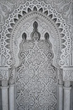 Arabic Patterns carved on a marble wall in Morocco Stock-Fotos
