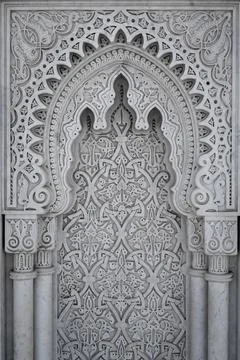Arabic Patterns carved on a marble wall in Morocco Foto stock
