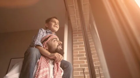 Arabic son and his and her father looking through the window. Isolation at home Stock Footage 127963451
