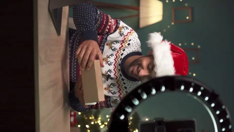 Arabic Tech vlogger doing unpacking review video of smartphone, while presenting Stock Footage 255442817