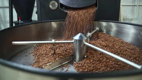 Arabica coffee beans pouring and roasting inside equipment in modern factory Stock Footage 165197053