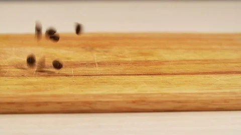 Arabica roasted coffee grain fall in slow motion from above wooden table closeup Stock Footage 118978894