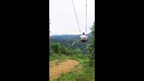 Araffe on a swing in the mountains. Stock Footage 282659104