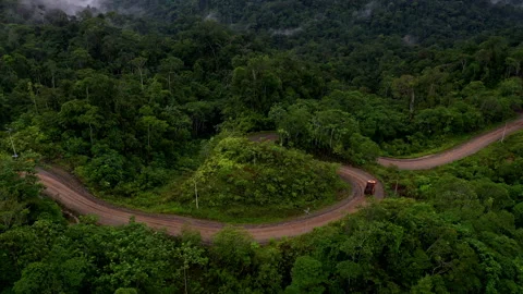 Arajuno, Ecuador, 14-7-2023: a large loading truck is driving over a dirtroad Stockbeeldmateriaal 336868074