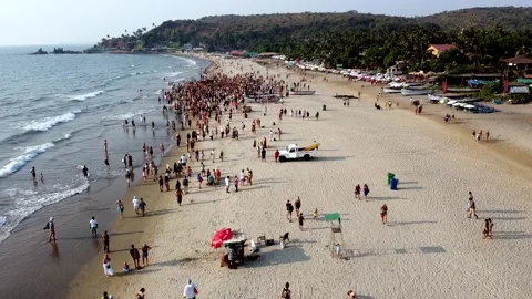 Arambol Goa India Freak Parade Carnival at the sunset beach drone fly over Stock Footage