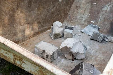 Arbage container with broken bricks Photos