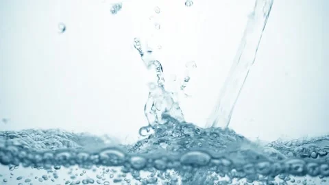 Arbonated stream of water in slow motion falls on smooth clean surface Video stock 134438548