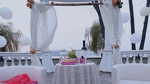 Arbor with decorations for a romantic dinner in the park against the backdrop of Stock Footage 80551162